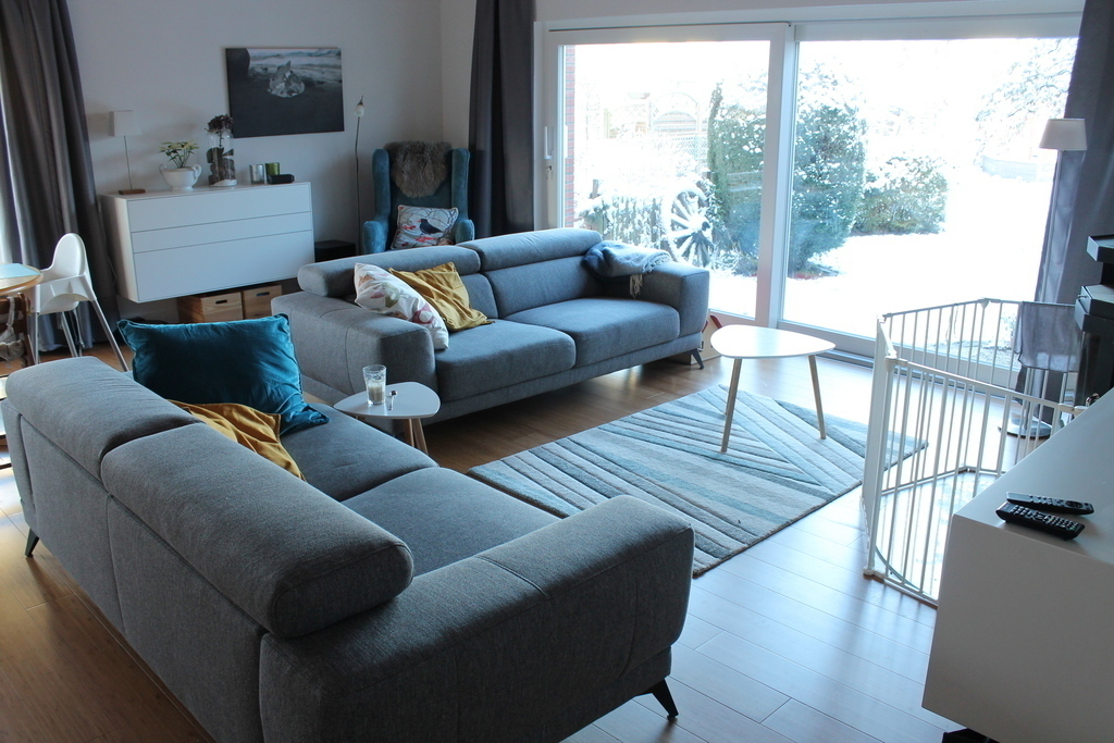 new living room with sofas and rear window into the garden