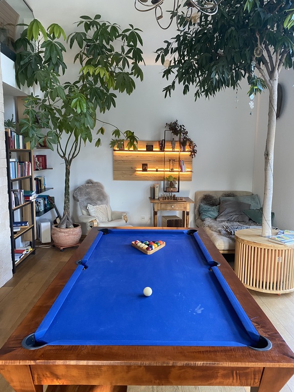 Our new table in the living room can be converted into a billiard  table. 