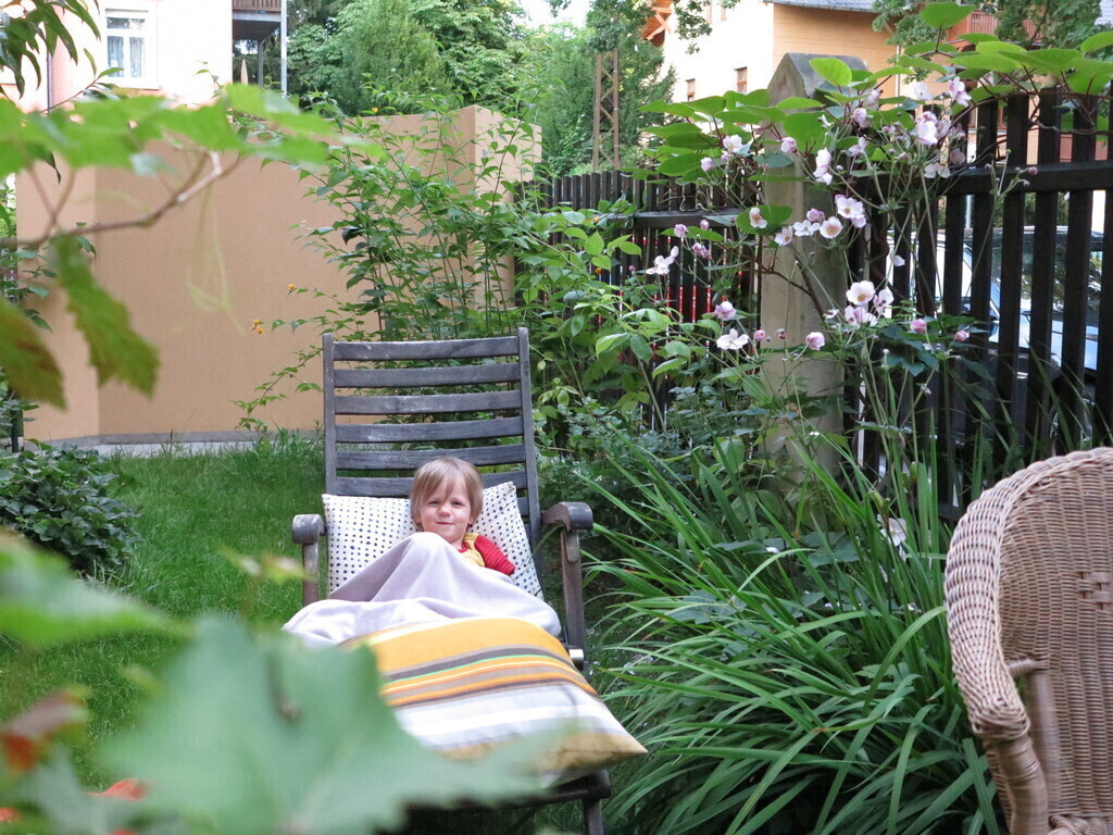 relaxing in our garden with flowers, strawberries, raspberries, red currant, gooseberries, grapes and tomatoes to pick for you