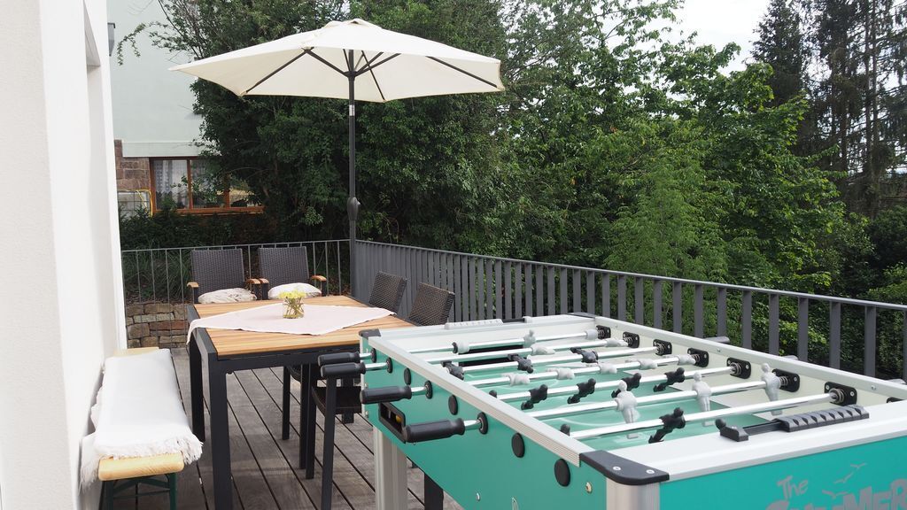 balcony with seating and table football