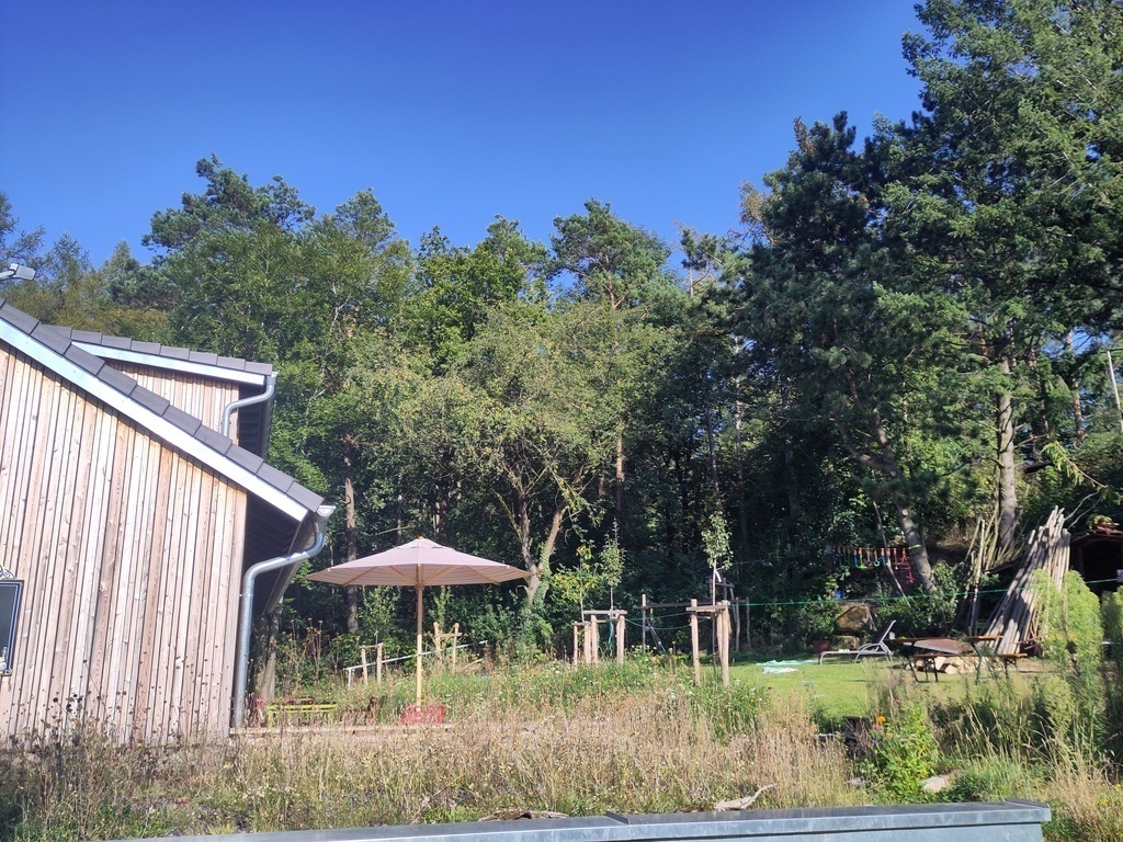 large garden with just a small footpath between garden and "wood"