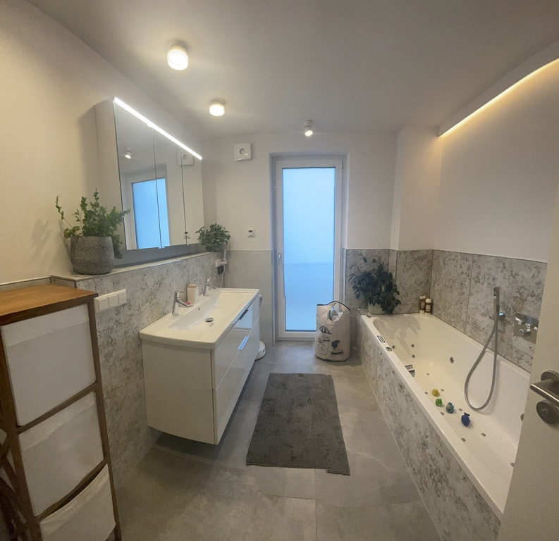 a bathroom with a whirlpool tub and shower on the first floor