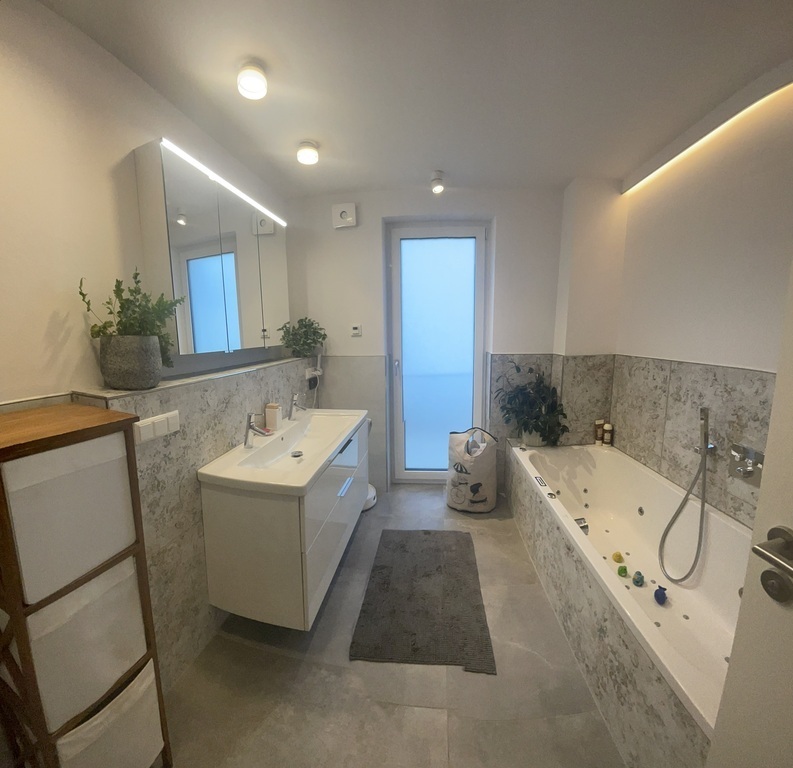 a bathroom with a whirlpool tub and shower on the first floor