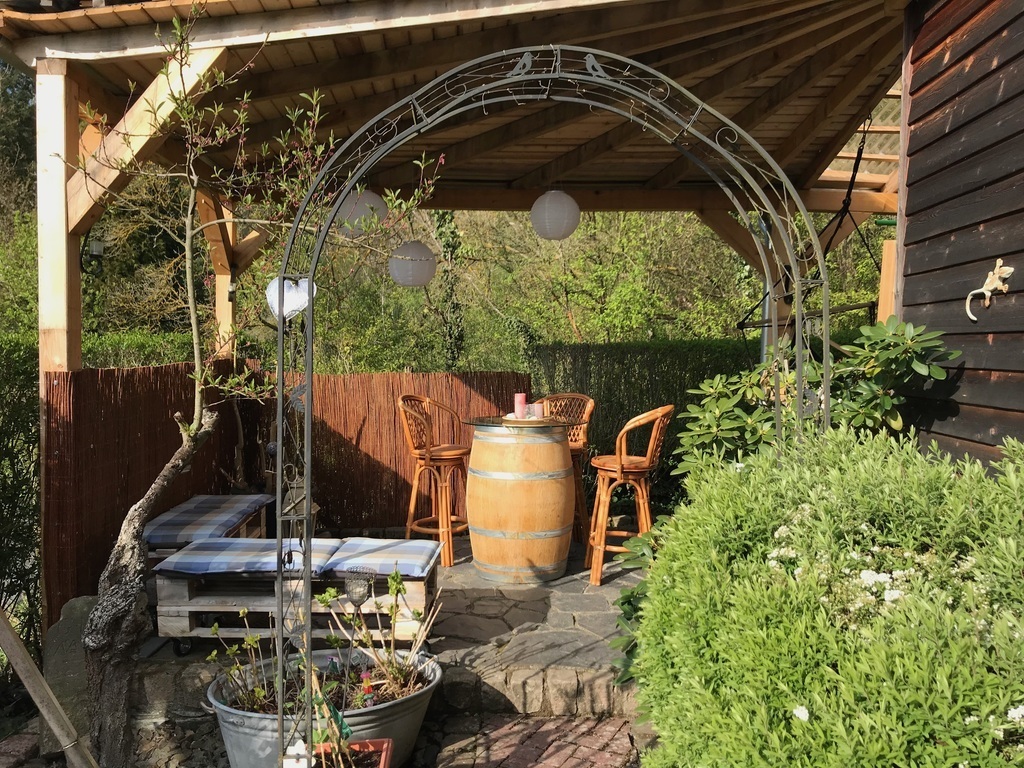 barbecue and place to sit besides and behind the house