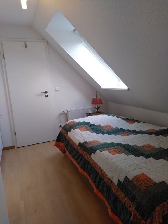 the bedroom  (  with the door   leading to the private bathroom )