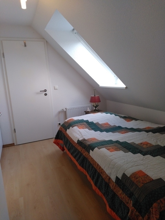 the bedroom  (  with the door   leading to the private bathroom )