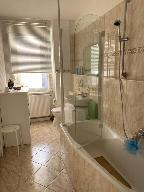 In the bathroom there is a bath and also a shower.