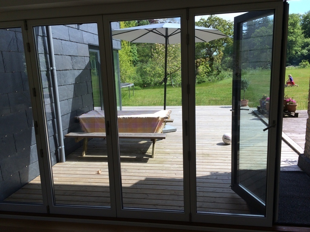 Summer dining area - the wall of doors open up to the patio
