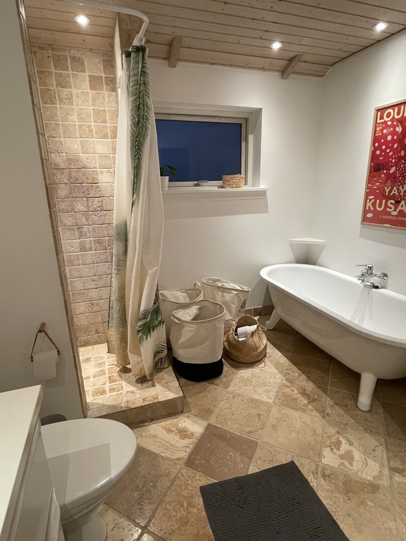 Bathroom 1, with toilet, shower, and bathtub