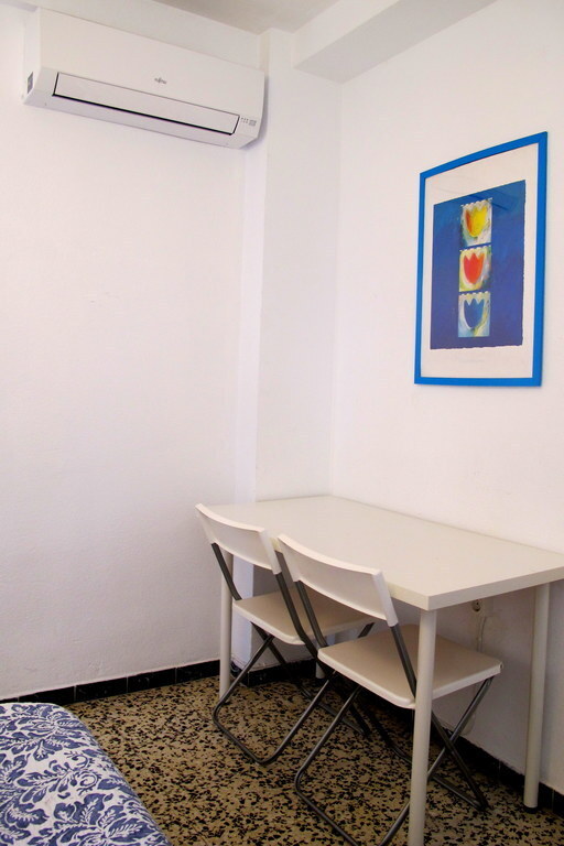 the master bedroom with a table and airconditioning