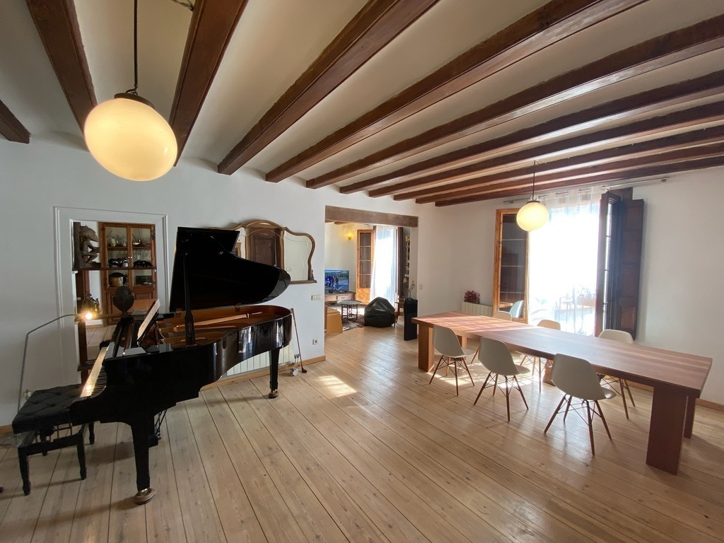 (Downstairs) Living Room Space 2, with piano and large dining table - 1/5
