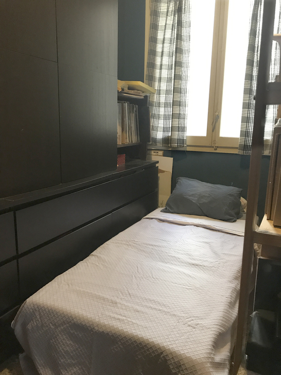 Wardrobe room with a folding bed