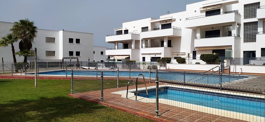 swimming pools with parasols and trees