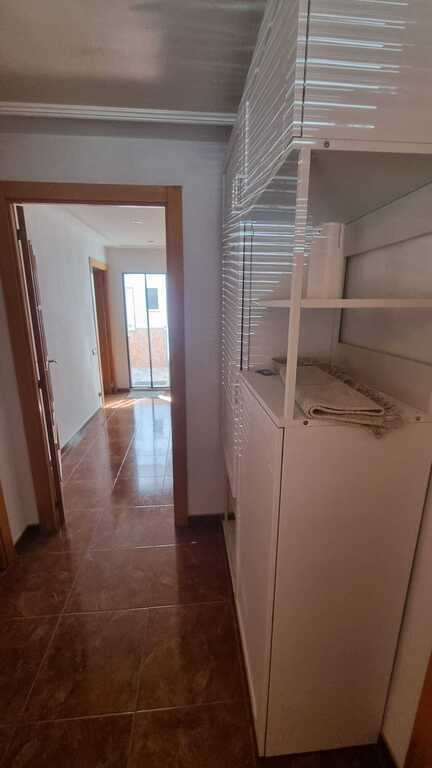 Photo of the living/dining room from the door to the kitchen. The window looks at the street. The door to the right is the en...