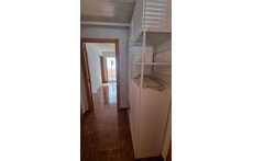 Photo of the living/dining room from the door to the kitchen. The window looks at the street. The door to the right is the en...