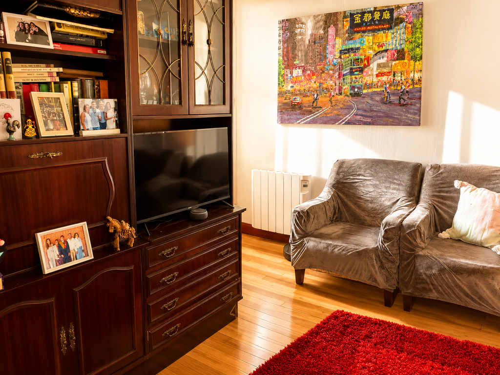 Comfortable living area with TV and balcony access