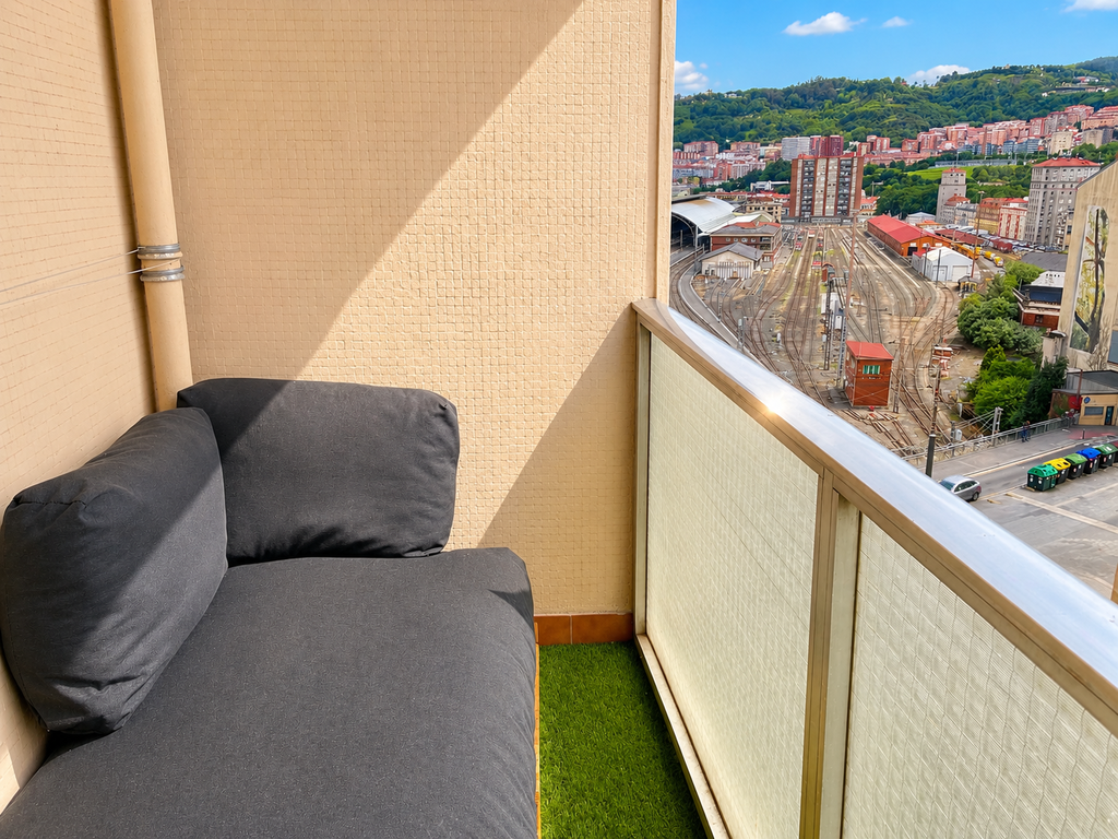 Balcony with seating area and panoramic Bilbao views
