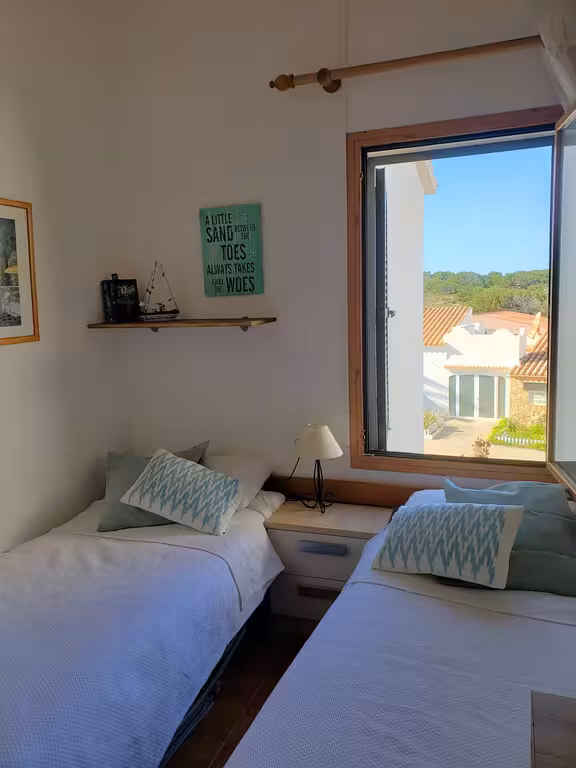 Comfortable twin bedroom with good storage space and lots of natural light, also with shutters on the window so ideal for little