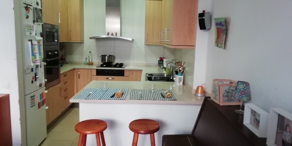 Kitchen open to the staying room with a counter to have meals