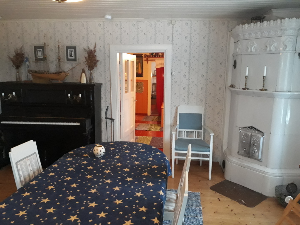 Dining room, piano and tile stove