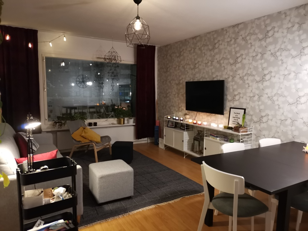 Living room with sofa bed and a dining table and access to the balcony.