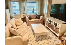 Livingroom is beside the balcony, other sofa has a bed in it too.