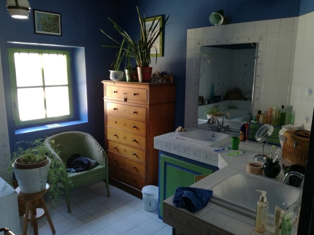 The bathroom upstairs with bath and shower