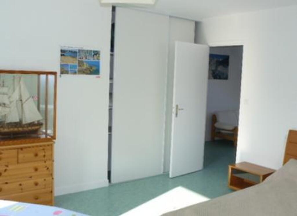 2nd bedroom, with cupboard and small furniture.