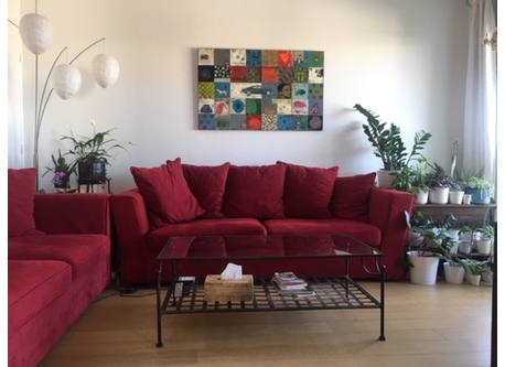 Our living room, with a lush vegetal balcony/terrasse, view over a garden, and the Eiffel Tower in the back