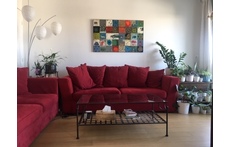 Our living room, with a lush vegetal balcony/terrasse, view over a garden, and the Eiffel Tower in the back