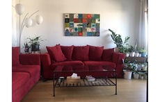 Our living room, with a lush vegetal balcony/terrasse, view over a garden, and the Eiffel Tower in the back