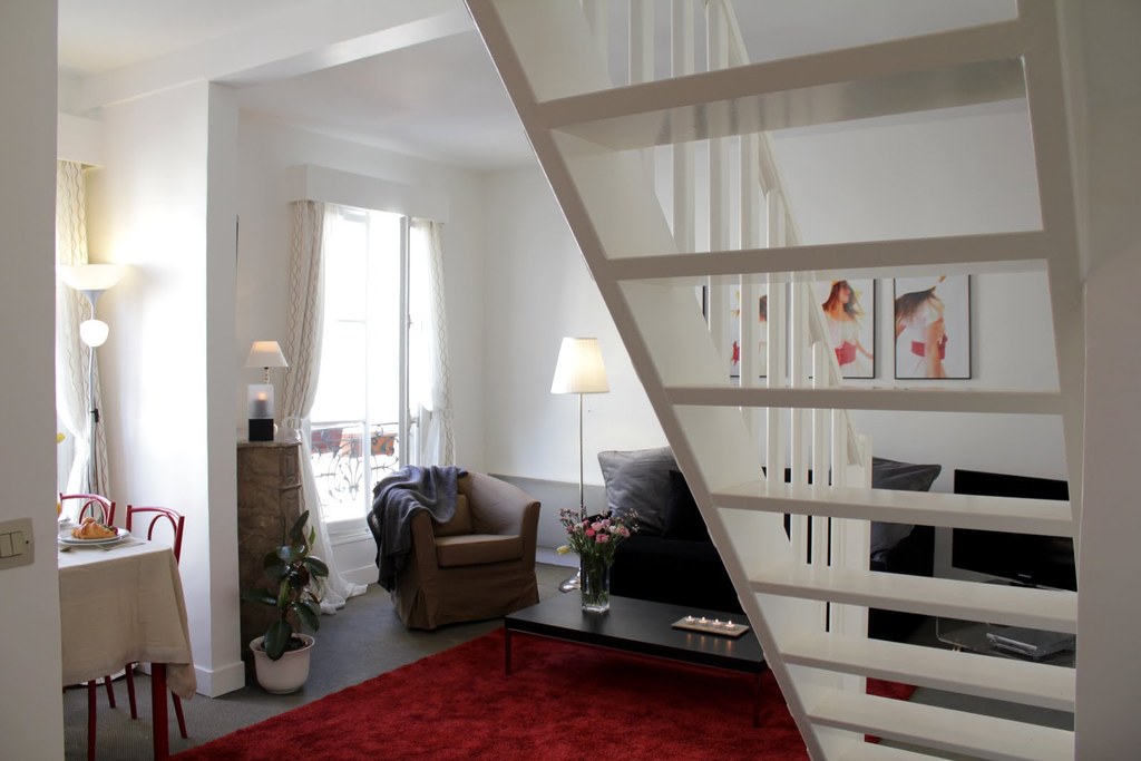 The living room has a very comfy sleeping sofa. Access to the bedroom and bathroom through the stairs