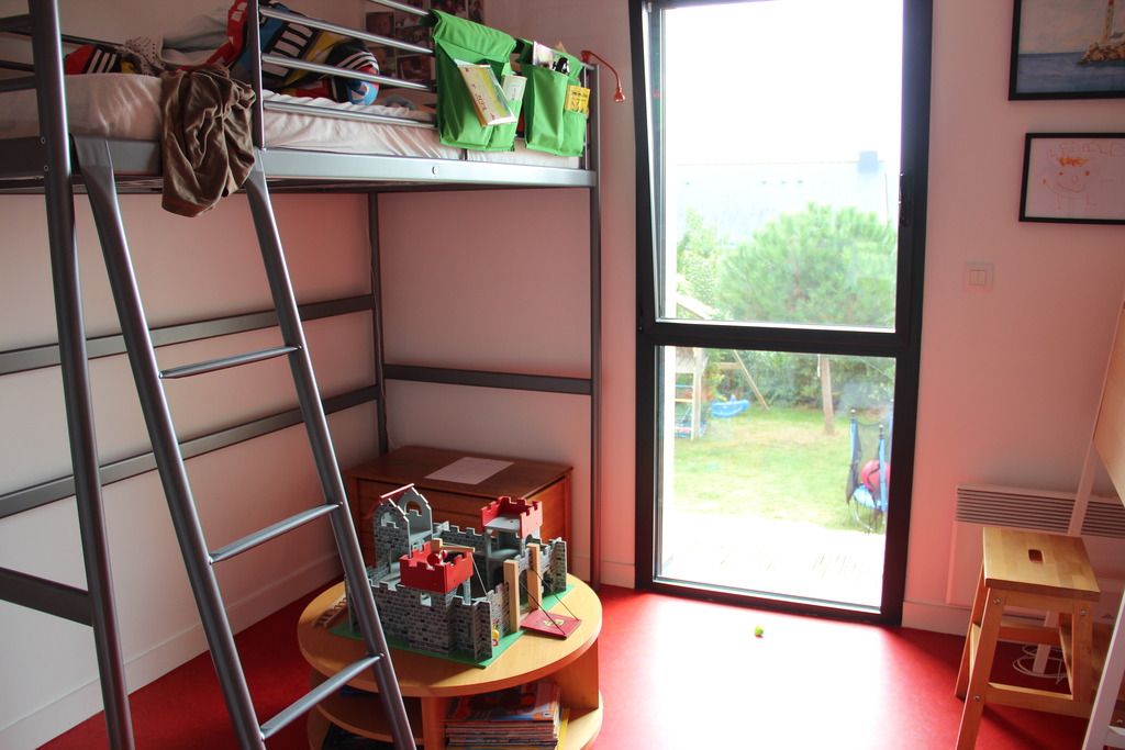 Red bedroom with a lot of toys