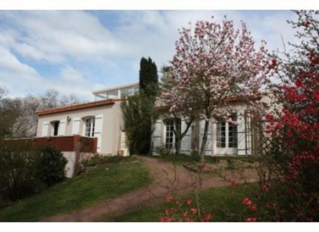 House in front of river on spring