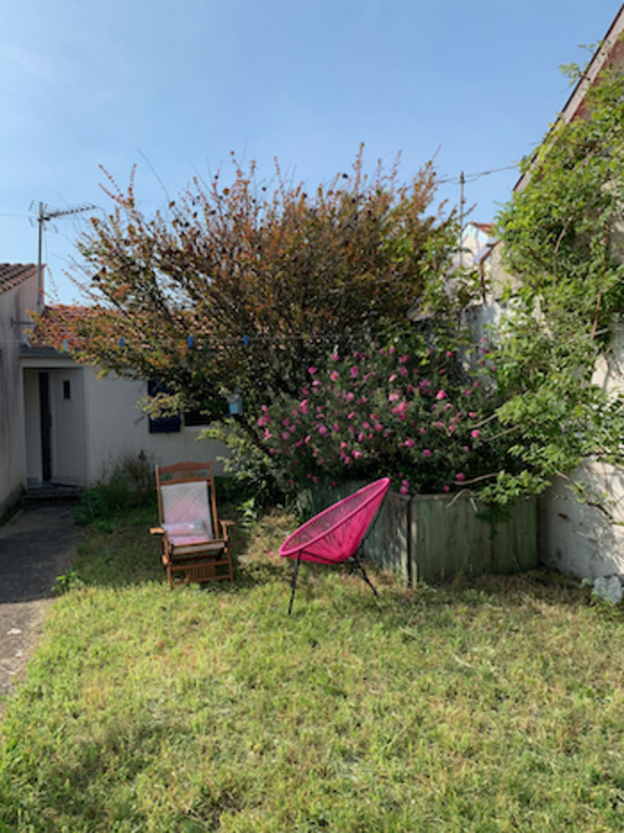 the  back garden with the small house that can sleep 4 people