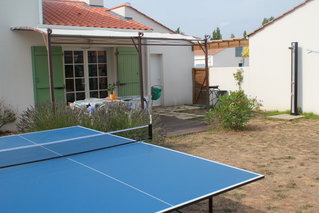 behind of the house, solar shower and ping pong table