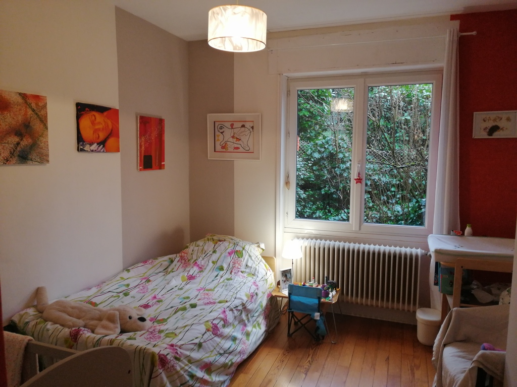 a bedroom with 2 beds and bed for baby