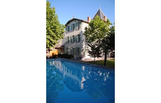 The swimmimg pool and the building: a former priory