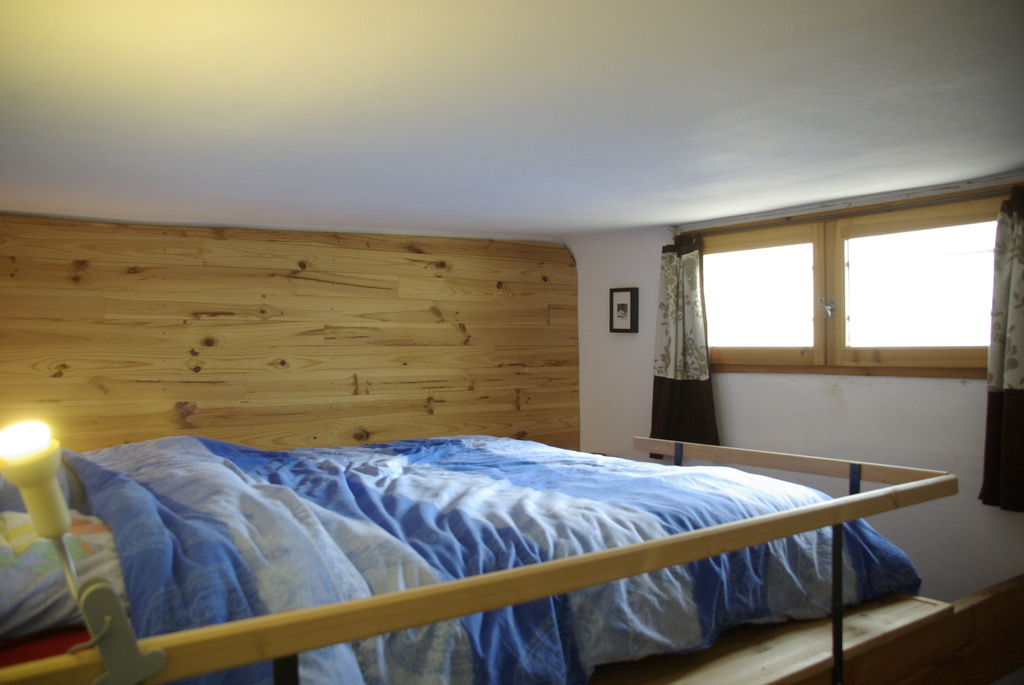 the bed in our room, on a mezzanine