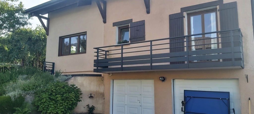 Entrance with automatic gate and garage doors and space to park.