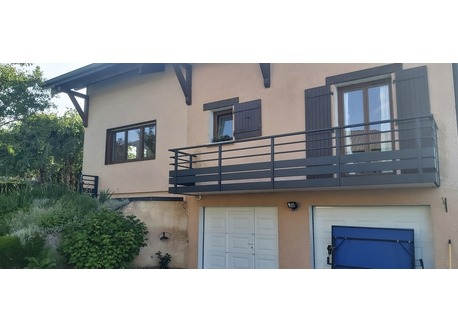 Entrance with automatic gate and garage doors and space to park.