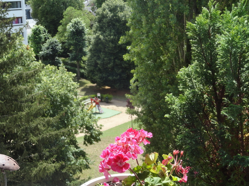 view from the balcony overlooking the park and a children's play area