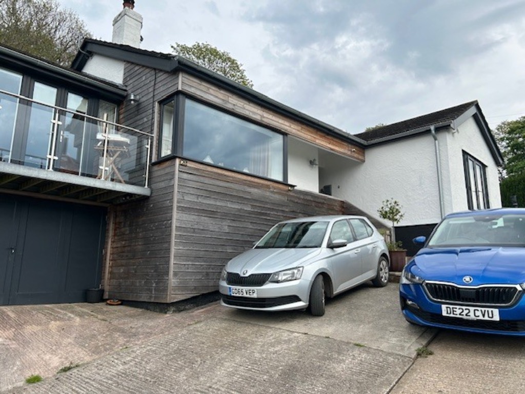 Front of house with parking spaces