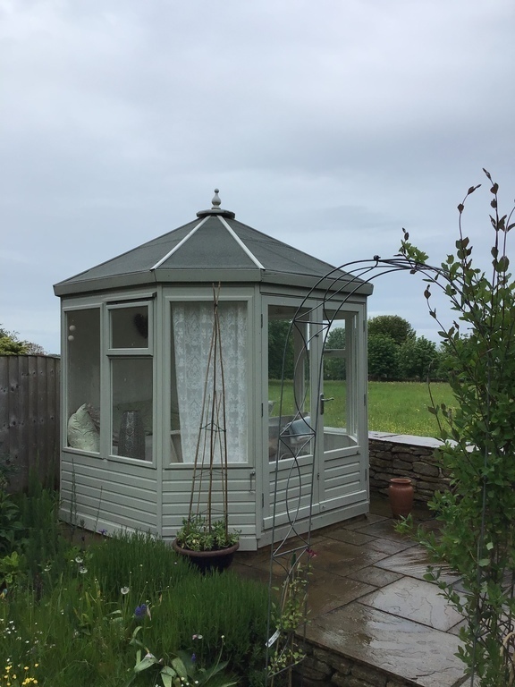 Summerhouse with lighting, heating, comfy seating and throws