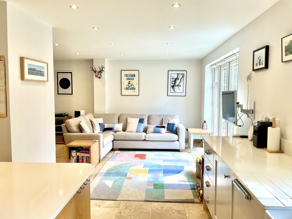 Sofa + TV area in kitchen / dining room. Plenty of kids' toys, games and books too! Doors out to the patio / garden 