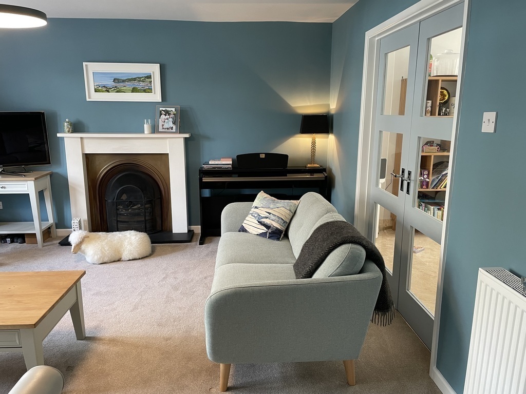 Sitting room with doors through to kitchen-dining area 