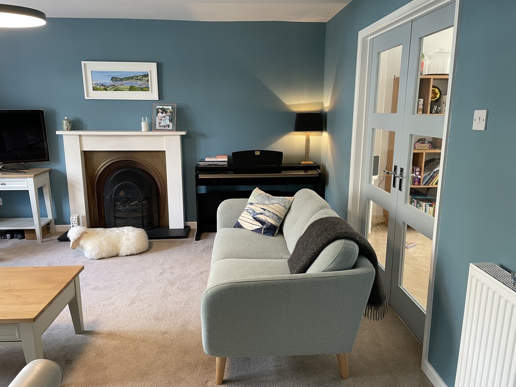 Sitting room with doors through to kitchen-dining area 