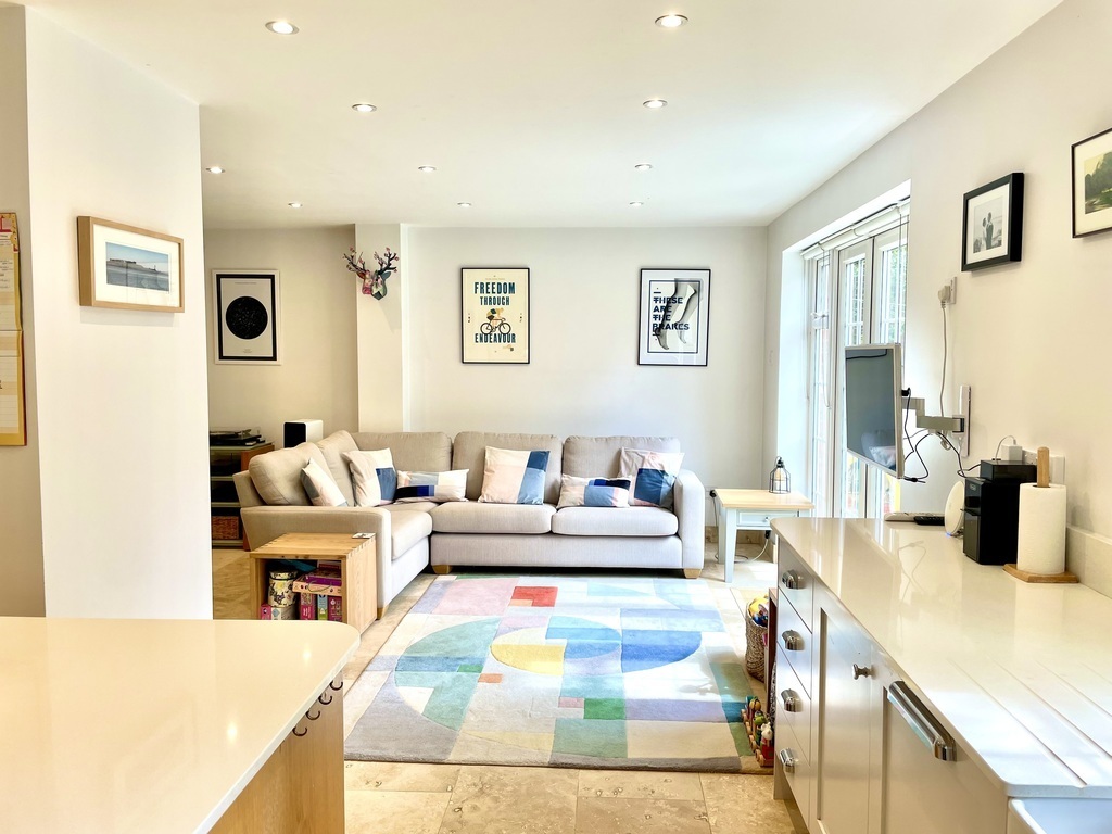 Sofa + TV area in kitchen / dining room. Plenty of kids' toys, games and books too! Doors out to the patio / garden 