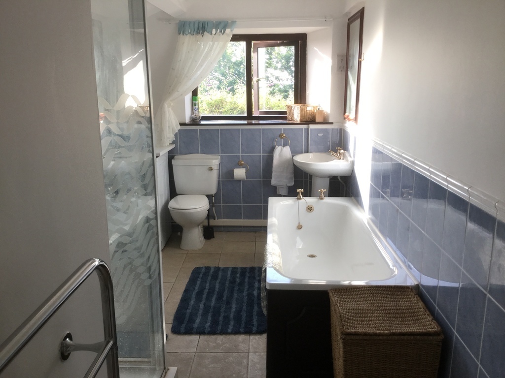 Bathroom with bath, shower, washing machine, tumble dryer