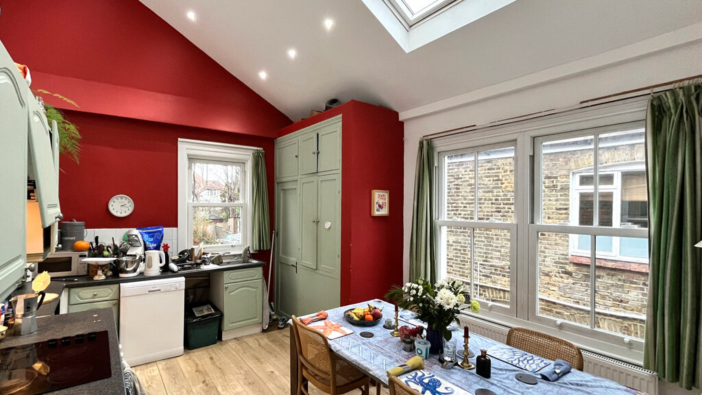 Spacious kitchen and dining area with very high ceiling.